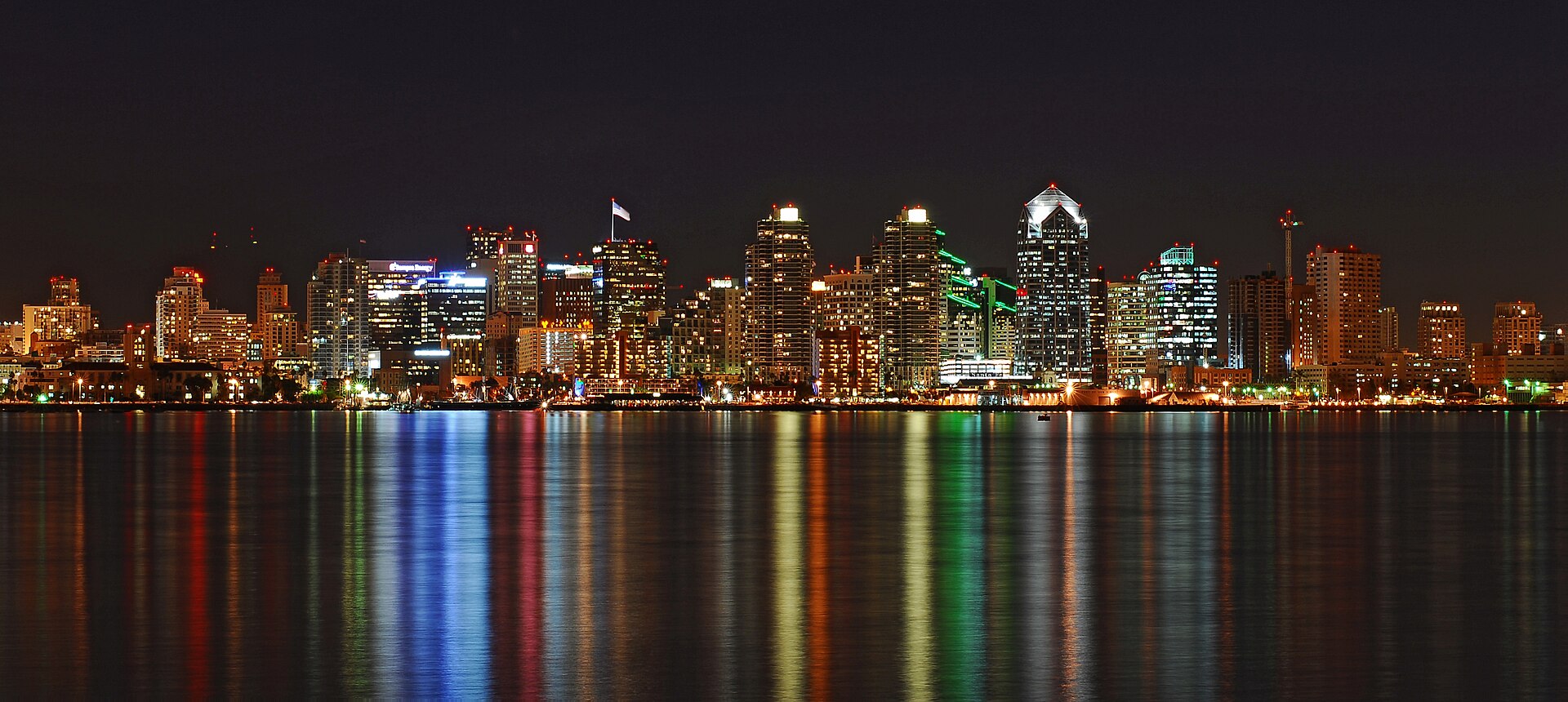 Downtown San Diego skyline reflected across the waterfront at night