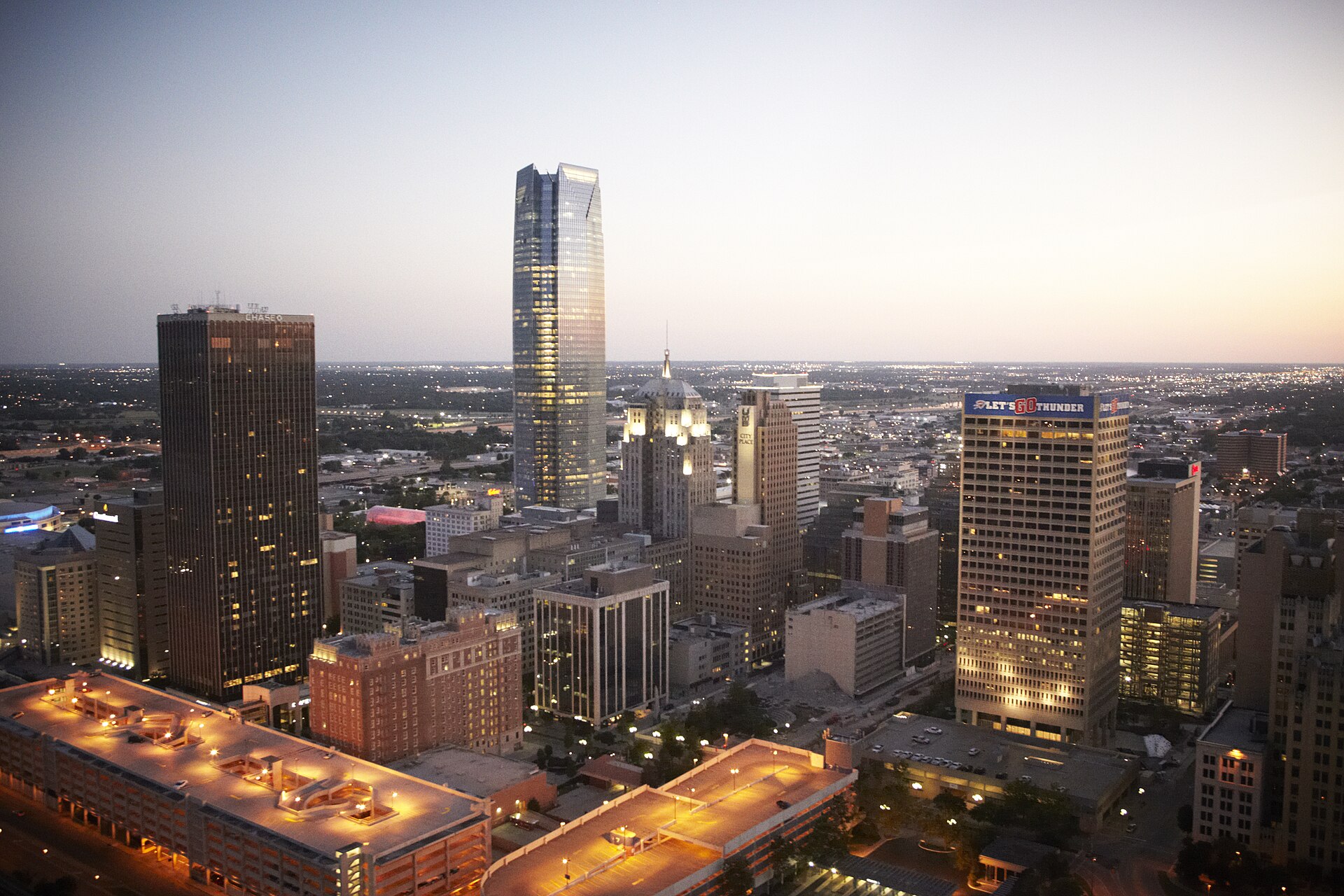 Downtown Oklahoma City skyline with illuminated high-rise towers at twilight